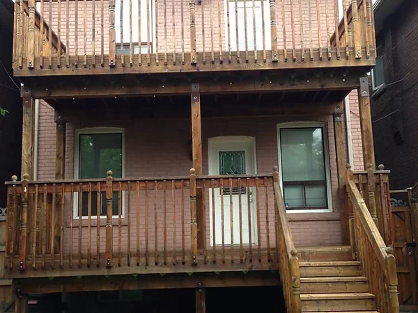 Outside home (emphasising a house-attached wooden deck and balcony) renovation.