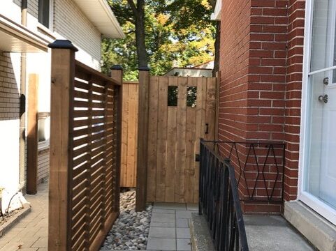 Area between two detached houses, featuring wooden fence work done by David's Quality Renovations.